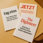Sie werden nicht ausgedruckt. Aber hier liegen, JETZT, tag eins und The Digioneer am Tisch